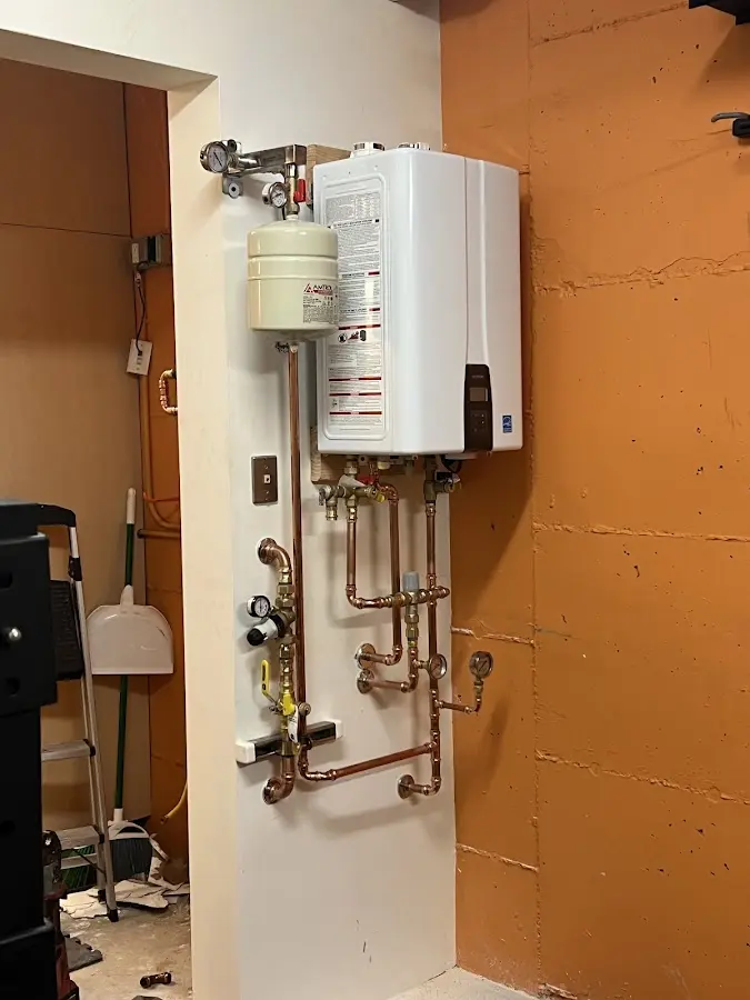Plumbing technician inspecting water heater connections in Bartow